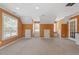 Large carpeted basement area with windows and built-in bench at 44 Clarke Ct, Angier, NC 27592