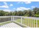 A white wooden deck with matching white railings offers great outdoor views of the manicured lawn at 44 Clarke Ct, Angier, NC 27592