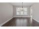 Spacious dining room featuring hardwood floors, a modern chandelier, and bright windows at 44 Clarke Ct, Angier, NC 27592