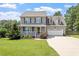 Charming two-story home featuring a cozy front porch and attached two-car garage at 44 Clarke Ct, Angier, NC 27592