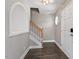 Bright foyer with hardwood floors, leading to staircase and featuring an arched nook at 44 Clarke Ct, Angier, NC 27592
