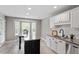 Well-lit kitchen featuring granite countertops, stainless steel appliances, and a breakfast nook at 44 Clarke Ct, Angier, NC 27592