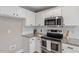 Modern kitchen with stainless steel appliances, white cabinets, and granite countertops at 44 Clarke Ct, Angier, NC 27592