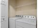 Laundry room with white washer and dryer, and overhead storage at 44 Clarke Ct, Angier, NC 27592