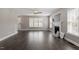 Open-concept living area with fireplace and hardwood floors and multiple windows at 44 Clarke Ct, Angier, NC 27592