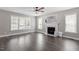Bright living room featuring hardwood floors, fireplace, and many large windows at 44 Clarke Ct, Angier, NC 27592