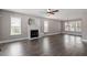 Spacious living room featuring a fireplace, modern ceiling fan, and hardwood flooring at 44 Clarke Ct, Angier, NC 27592