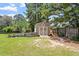 Backyard shed with fencing and a trellised garden at 44 Clarke Ct, Angier, NC 27592