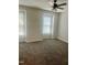 Bright bedroom featuring neutral carpet and multiple windows for natural light at 4418 Roller Ct, Raleigh, NC 27604
