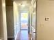 Inviting hallway with light walls, white trim, and a view to the front door at 4418 Roller Ct, Raleigh, NC 27604