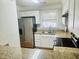 Bright kitchen with stainless steel appliances, granite countertops, and white cabinets at 4418 Roller Ct, Raleigh, NC 27604