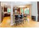 Open kitchen featuring a breakfast bar, cherry cabinets, stainless steel appliances, and wood floors at 5240 Indigo Moon Way, Raleigh, NC 27613