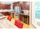 This kitchen features a stainless steel fridge, dark wood cabinets, and granite countertops at 5240 Indigo Moon Way, Raleigh, NC 27613