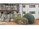 Multi-level condo building featuring wood balconies, neutral siding, and well-maintained landscaping with pine straw at 550 Pine Ridge Pl, Raleigh, NC 27609