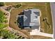 Aerial view of the landscaped property with a patio, outdoor kitchen and manicured lawn at 623 Westfall Way, Chapel Hill, NC 27517