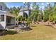 Backyard featuring a large patio with outdoor seating and views of the lush, green surroundings at 623 Westfall Way, Chapel Hill, NC 27517