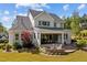Backyard featuring a large patio with outdoor seating and views of the lush, green surroundings at 623 Westfall Way, Chapel Hill, NC 27517