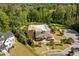 Aerial view of large community pool surrounded by trees, landscaping, sidewalks, parking and a clubhouse at 623 Westfall Way, Chapel Hill, NC 27517