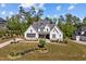 Charming home with gray roof, stone accents, and landscaping creates a welcoming curb appeal at 623 Westfall Way, Chapel Hill, NC 27517
