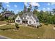 Aerial view of a beautiful modern farmhouse with lush landscaping at 623 Westfall Way, Chapel Hill, NC 27517