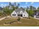 Aerial view of a modern farmhouse with a well-manicured lawn at 623 Westfall Way, Chapel Hill, NC 27517
