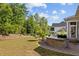 Outdoor kitchen area featuring a countertop bar, brick surround and spacious lawn at 623 Westfall Way, Chapel Hill, NC 27517