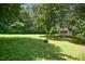 A large backyard with an outbuilding provides ample space for outdoor activities and storage at 6308 Rolling Acres Drive, Gibsonville, NC 27249