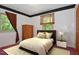 Bedroom featuring a large window with blinds and curtains, wooden bed frame and closet at 6308 Rolling Acres Drive, Gibsonville, NC 27249