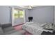 Bedroom featuring a ceiling fan, window and large bed and sofa at 6308 Rolling Acres Drive, Gibsonville, NC 27249