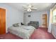 Bright bedroom features a ceiling fan, large bed, and comfortable seating area at 6308 Rolling Acres Drive, Gibsonville, NC 27249