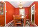 Inviting dining room featuring a wooden table, patterned rug and hanging light fixture at 6308 Rolling Acres Drive, Gibsonville, NC 27249
