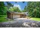 Charming home featuring a brick exterior, a two-car garage and a well-maintained lawn with mature trees at 6308 Rolling Acres Drive, Gibsonville, NC 27249