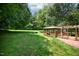 A beautiful gazebo with a porch swing offers a relaxing outdoor space in the lush backyard at 6308 Rolling Acres Drive, Gibsonville, NC 27249