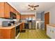 Functional kitchen with stainless steel appliances, wood cabinets and patterned flooring at 6308 Rolling Acres Drive, Gibsonville, NC 27249