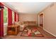Cozy living room with large sectional couch, colorful rug and natural light at 6308 Rolling Acres Drive, Gibsonville, NC 27249