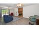 Spacious living room with fireplace, built-in shelves, and sliding glass doors at 6308 Rolling Acres Drive, Gibsonville, NC 27249