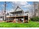 View of the rear exterior featuring a screened porch and a lower level patio with outdoor seating at 651 Sagamore Dr, Louisburg, NC 27549
