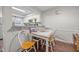 Eat-in dining area showcasing a breakfast bar and adjacent galley kitchen with white cabinets at 7020 Longstreet Dr # A, Raleigh, NC 27615