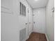 Bright entryway with white walls, a wood-look floor, and a coat rack for storage at 7020 Longstreet Dr # A, Raleigh, NC 27615