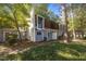 Exterior view of a two-story townhouse featuring a well-kept lawn and mature trees at 7020 Longstreet Dr # A, Raleigh, NC 27615