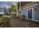 View of the townhouse exterior highlighting the walkway, door, and well-manicured landscaping at 7020 Longstreet Dr # A, Raleigh, NC 27615