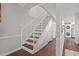 Interior hallway with stairs and access to the washer and dryer at 7020 Longstreet Dr # A, Raleigh, NC 27615