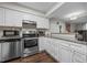 Kitchen with stainless steel appliances, ample counter space, and white cabinets at 7020 Longstreet Dr # A, Raleigh, NC 27615