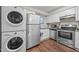 Kitchen featuring stainless steel appliances, white cabinetry, and stacked washer and dryer at 7020 Longstreet Dr # A, Raleigh, NC 27615