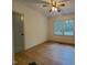 Bright bedroom with hardwood floors, ceiling fan and natural light from a large window at 719 E Whitaker Mill Rd, Raleigh, NC 27608