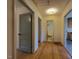 Hallway showcasing hardwood floors leading to the bathroom, kitchen, and other rooms at 719 E Whitaker Mill Rd, Raleigh, NC 27608