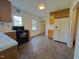 Functional kitchen with linoleum floors, and ample storage space with white appliances at 719 E Whitaker Mill Rd, Raleigh, NC 27608