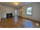 Bright living room features a fireplace, hardwood floors, and large windows for natural light at 719 E Whitaker Mill Rd, Raleigh, NC 27608