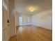 Inviting living room features hardwood floors and a light fixture and neutral wall colors at 719 E Whitaker Mill Rd, Raleigh, NC 27608
