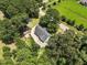 A bird's eye view of the house, revealing its position near the road and surrounded by verdant trees at 7722 Nc 27, Lillington, NC 27546